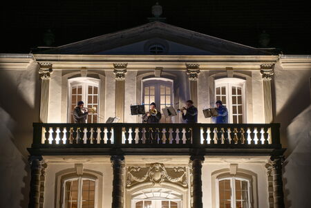 Exterior view of the castle with brass quartet on the balcony