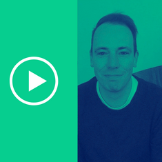 Portrait photo of author Konrad H Roenne with play button next to it – link to video