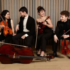 a portrait photo of the ensemble with their instruments